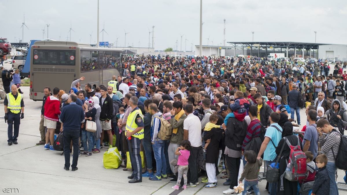 Migrants wait to be boarded to buses from the Austrian-Hungarian border to a train station in the Austrian village of Nickelsdorf on September 5, 2015 to take a train to Vienna.Thousands of migrants streamed into Austria from Hungary, in what Vienna called a "wake up call" for Europe to get to grips with its biggest refugee influx since World War II. AFP PHOTO / JOE KLAMAR (Photo credit should read JOE KLAMAR/AFP/Getty Images)